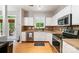 Bright kitchen with stainless steel appliances, ample counter space, and hardwood floors at 3915 Planters Watch Dr, Charlotte, NC 28278