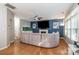 Open-concept living room with hardwood floors, fireplace, and large sectional sofa at 3915 Planters Watch Dr, Charlotte, NC 28278