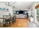 Open-concept dining and living area with hardwood floors and lots of natural light at 3915 Planters Watch Dr, Charlotte, NC 28278