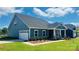 Lovely blue home featuring a garage, inviting covered front porch and manicured landscaping at 407 Bent Burr Crk, York, SC 29745