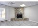 Finished basement showcasing stone fireplace, grey floors, white walls, and walkout to backyard at 4516 Kiser Island Rd # 1, Terrell, NC 28682