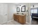 Bathroom with double sinks, granite countertops, and a view of the bed and a window at 4516 Kiser Island Rd # 1, Terrell, NC 28682