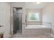 Bathroom with a stand-up shower, a soaking tub, and a large window with lots of natural light at 4516 Kiser Island Rd # 1, Terrell, NC 28682
