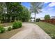 Long driveway leading to a beautiful lakeside home surrounded by lush greenery and mature trees at 4516 Kiser Island Rd # 1, Terrell, NC 28682