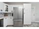 Modern kitchen with stainless steel refrigerator, white cabinetry, and stylish backsplash design at 4516 Kiser Island Rd # 1, Terrell, NC 28682