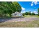 Exterior view showcasing the backyard and side of the house with a spacious parking area at 5785 Nc 150 E Hwy, Denver, NC 28037