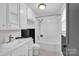 Bathroom with white tile, a bath tub, shower and sink at 5785 Nc 150 E Hwy, Denver, NC 28037