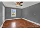 Bedroom with wood floors, neutral paint, and a window providing natural light at 5785 Nc 150 E Hwy, Denver, NC 28037