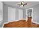 Bedroom featuring hardwood floors and two closets and an adjoined doorway to another room at 5785 Nc 150 E Hwy, Denver, NC 28037