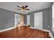 Bedroom with wood floors, neutral paint, a barn door and a ceiling fan at 5785 Nc 150 E Hwy, Denver, NC 28037