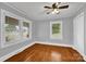 Bedroom with hardwood floors, neutral paint, and natural light coming through multiple windows at 5785 Nc 150 E Hwy, Denver, NC 28037