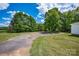 Image features the spacious driveway and surrounding green space of the property at 5785 Nc 150 E Hwy, Denver, NC 28037