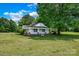 Charming single-story home featuring a brick foundation and a welcoming covered front porch at 5785 Nc 150 E Hwy, Denver, NC 28037