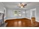 Living room featuring gleaming hardwood floors, a decorative fireplace, and bright natural light at 5785 Nc 150 E Hwy, Denver, NC 28037