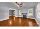 Bright living room showcasing hardwood floors, a classic fireplace, and an open doorway at 5785 Nc 150 E Hwy, Denver, NC 28037