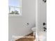 Bathroom with wood-look flooring and white fixtures at 5820 Pittmon Ln, Kannapolis, NC 28081