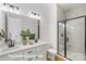 Beautiful bathroom features double vanity, shower with black trim and marble-look tile surround at 5820 Pittmon Ln, Kannapolis, NC 28081