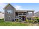 Backyard includes a patio with seating, an upper deck, and mature landscaping at 6008 Candlestick Ln, Lancaster, SC 29720