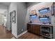 Stylish bar area with stone accent wall, display shelves, and built-in wine refrigerator at 6008 Candlestick Ln, Lancaster, SC 29720