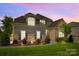 Charming two-story home featuring stone accents, a well-manicured lawn, and attractive landscaping at 6008 Candlestick Ln, Lancaster, SC 29720