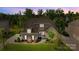 Aerial view showcasing the home's architectural details, surrounding trees, and lush green lawn at 6008 Candlestick Ln, Lancaster, SC 29720