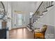 Bright foyer featuring a staircase, hardwood floors, and a glass front door for natural light at 6008 Candlestick Ln, Lancaster, SC 29720
