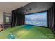 Finished basement features a golf simulator with recessed lighting, an artificial putting green, and curtains at 6008 Candlestick Ln, Lancaster, SC 29720