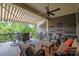 Inviting covered patio with comfortable seating, ceiling fan, and retractable awning overlooking beautiful greenery at 6008 Candlestick Ln, Lancaster, SC 29720
