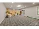 Large recreation room with a wood accent wall, a putting green, and seating at 6008 Candlestick Ln, Lancaster, SC 29720