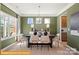 Bright dining room is accentuated with a green accent wall, a modern chandelier, and lots of natural light at 6443 Honor Ave, Midland, NC 28107
