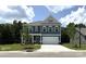 Inviting two-story home boasts a well-manicured lawn and a charming facade with a two-car garage at 6443 Honor Ave, Midland, NC 28107