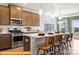 Stylish kitchen with stainless steel appliances, kitchen island seating, and wooden cabinets at 6443 Honor Ave, Midland, NC 28107