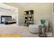 Relaxing sitting area adjacent to the bedroom with natural light and a bookcase at 6443 Honor Ave, Midland, NC 28107