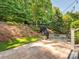 Backyard patio area with comfortable seating, a firepit, and professional landscaping at 7040 Edenderry Dr, Charlotte, NC 28270