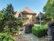 Lush backyard featuring a fire pit, patio, and mature trees at 7040 Edenderry Dr, Charlotte, NC 28270