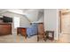 Comfortable bedroom with a ceiling fan, wooden furniture, and an accent rocking chair at 7040 Edenderry Dr, Charlotte, NC 28270