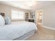 Comfortable bedroom with a large window, ceiling fan, and ensuite bath access at 7040 Edenderry Dr, Charlotte, NC 28270