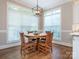 Dining area featuring a round table, wood chairs, and large windows for natural light at 7040 Edenderry Dr, Charlotte, NC 28270