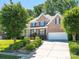 Charming brick home with well-manicured landscaping and a two-car garage at 7040 Edenderry Dr, Charlotte, NC 28270