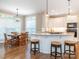 Charming kitchen with bar stool seating that adjoins a lovely, sunlit dining area at 7040 Edenderry Dr, Charlotte, NC 28270