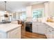 Clean kitchen with white countertops and cabinets adjoins a dining area and fireplace at 7040 Edenderry Dr, Charlotte, NC 28270