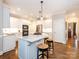Stylish kitchen with a bright island, bar stool seating, and modern appliances at 7040 Edenderry Dr, Charlotte, NC 28270