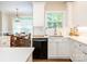 Bright kitchen featuring white cabinets and quartz countertops adjoins a charming dining area at 7040 Edenderry Dr, Charlotte, NC 28270