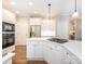 Well-lit kitchen with white cabinets, stainless steel appliances, and a convenient center island at 7040 Edenderry Dr, Charlotte, NC 28270