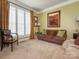 Cozy living room with a comfortable sofa, artwork, and natural light from the window at 7040 Edenderry Dr, Charlotte, NC 28270