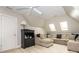 Living room with a comfortable couch, skylights, and a ceiling fan at 7040 Edenderry Dr, Charlotte, NC 28270