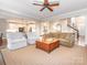Bright living room with open floor plan, featuring a large area rug and neutral furniture at 7040 Edenderry Dr, Charlotte, NC 28270