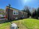 Side of brick home with green lawn and utility features along exterior wall at 739 Owls Den Rd, Lincolnton, NC 28092
