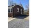 Brick home with a wooden ramp leading to the back entrance with gravel in backyard at 739 Owls Den Rd, Lincolnton, NC 28092