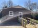 Back of brick home featuring a wooden ramp leading to the back door entrance at 739 Owls Den Rd, Lincolnton, NC 28092